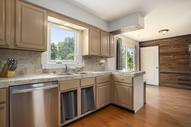 1602 Mccann Rd, Hastings, MI 49058 - kitchen with stainless steel dishwasher, a peninsula, light countertops, light wood-style floors, and tasteful backsplash