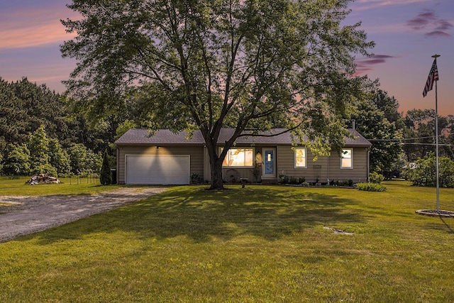 1602 Mccann Rd, Hastings, MI 49058 - view of front facade with dirt driveway, a garage, and a front lawn