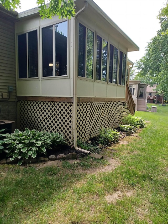 3144 Amsterdam Dr, Clio, MI 48420 - view of side of property featuring a sunroom and a lawn