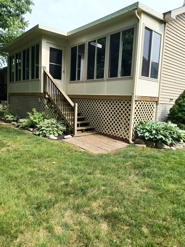 3144 Amsterdam Dr, Clio, MI 48420 - back of house featuring a yard, a sunroom, and stairs