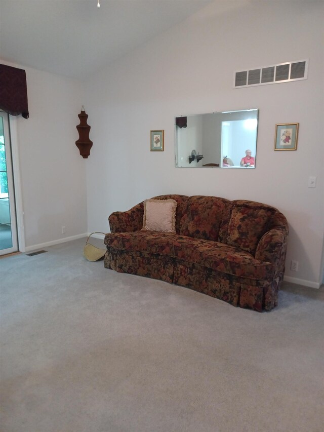 3144 Amsterdam Dr, Clio, MI 48420 - carpeted living area with vaulted ceiling and baseboards