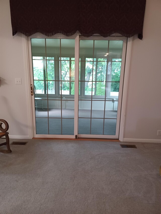 3144 Amsterdam Dr, Clio, MI 48420 - doorway featuring carpet floors and baseboards