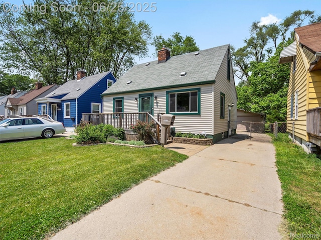 34286 Glover St, Wayne, MI 48184 - view of front of house featuring a chimney, a deck, a shingled roof, and concrete driveway