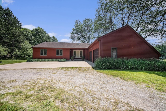 7385 Macomber Ct, Ann Arbor, MI 48103 - view of front of house with a garage, driveway, and a front lawn