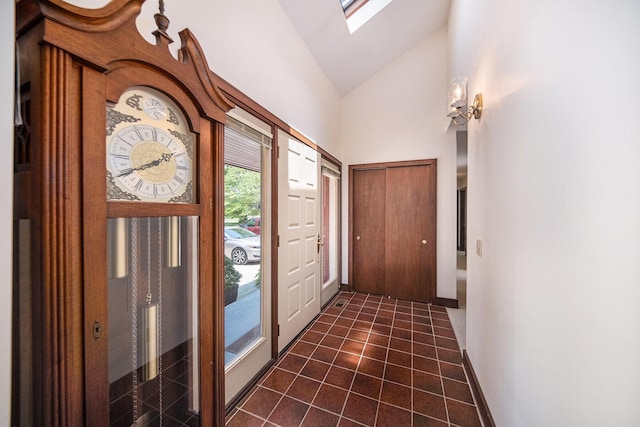 7385 Macomber Ct, Ann Arbor, MI 48103 - foyer entrance featuring lofted ceiling, dark tile patterned flooring, and a skylight