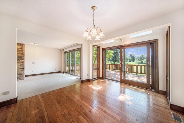 7385 Macomber Ct, Ann Arbor, MI 48103 - spare room with hardwood / wood-style floors and a chandelier