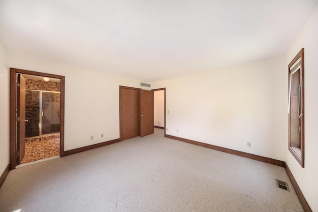 7385 Macomber Ct, Ann Arbor, MI 48103 - unfurnished bedroom with light carpet, connected bathroom, and a closet