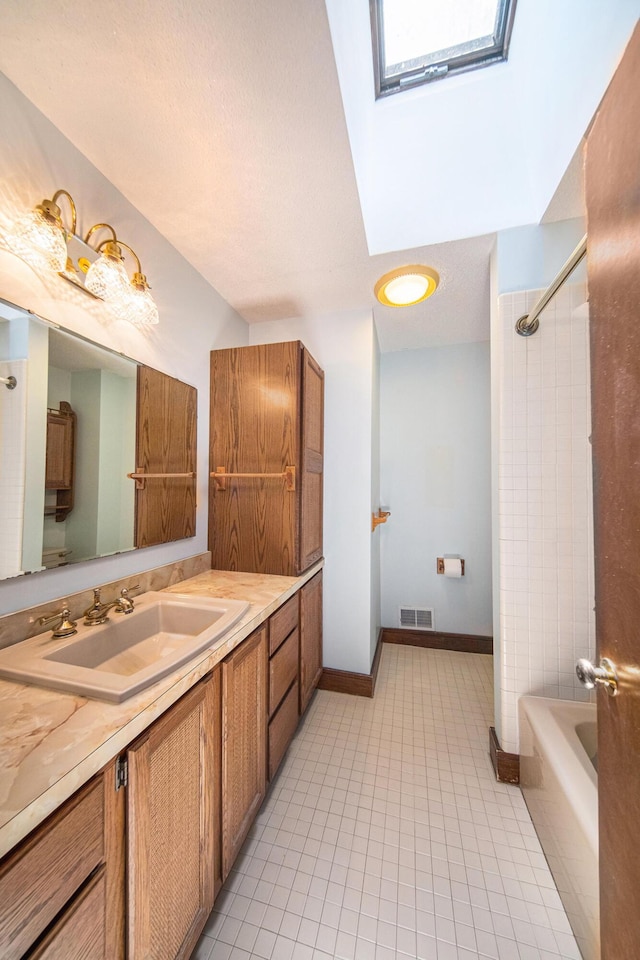 7385 Macomber Ct, Ann Arbor, MI 48103 - bathroom featuring a skylight, vanity, shower / bath combination, and tile patterned flooring