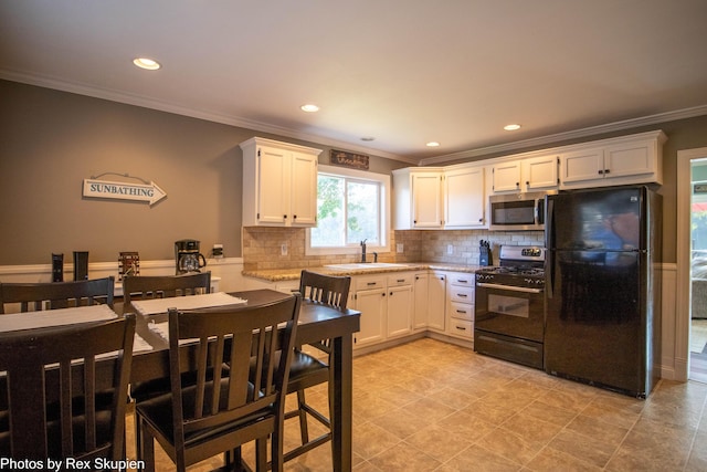 4767 S River St, Newaygo, MI 49337 - kitchen featuring freestanding refrigerator, range with gas cooktop, stainless steel microwave, ornamental molding, and backsplash