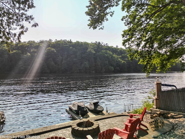 4767 S River St, Newaygo, MI 49337 - dock with a fire pit, a water view, and a wooded view