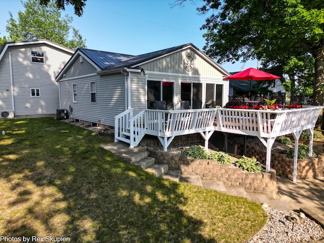 4767 S River St, Newaygo, MI 49337 - rear view of property with a deck, a yard, and a metal roof