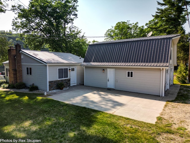 4767 S River St, Newaygo, MI 49337 - view of front of property with a metal roof, a front yard, a gambrel roof, and a chimney