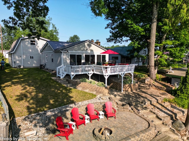 4767 S River St, Newaygo, MI 49337 - view of front of home with an outdoor fire pit, a patio, a wooden deck, and a front yard