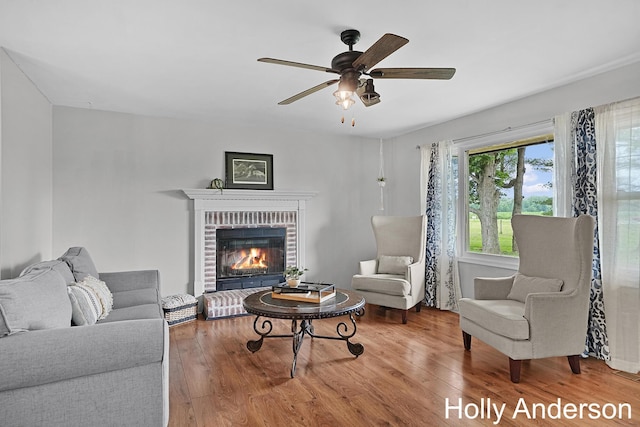 37137 30th St, Paw Paw, MI 49079 - living area featuring wood finished floors, ceiling fan, and a fireplace