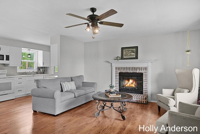 37137 30th St, Paw Paw, MI 49079 - living area with a ceiling fan, light wood-style floors, and a brick fireplace