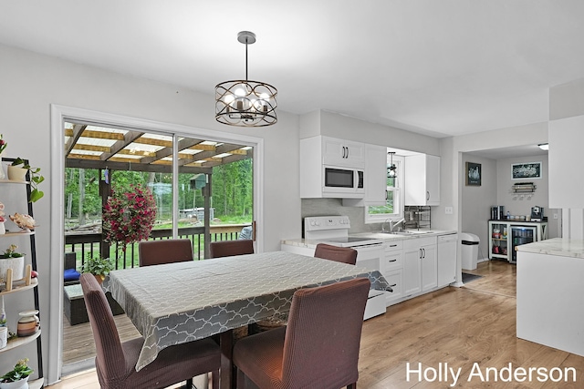37137 30th St, Paw Paw, MI 49079 - dining room with light wood-style flooring, a chandelier, and beverage cooler