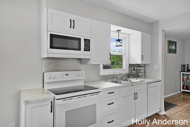 37137 30th St, Paw Paw, MI 49079 - kitchen featuring white appliances, decorative backsplash, wood finished floors, and white cabinets