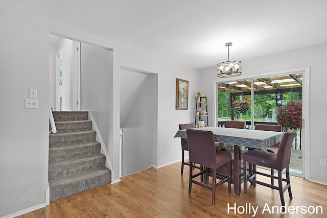 37137 30th St, Paw Paw, MI 49079 - dining area featuring light wood-style flooring, stairs, and a chandelier