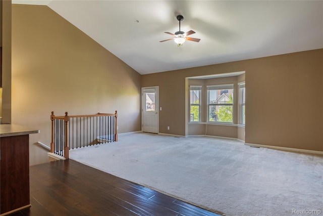25556 Portico Ln, Novi, MI 48375 - empty room featuring a ceiling fan, wood finished floors, carpet, and high vaulted ceiling