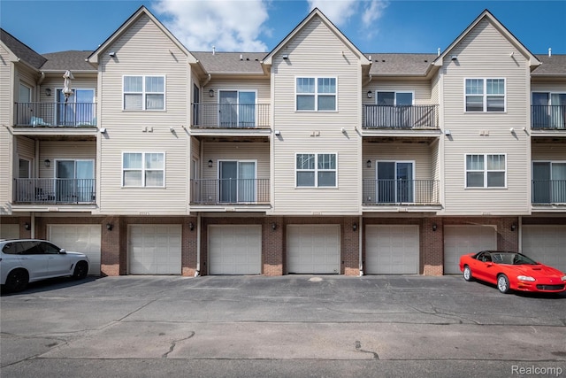 25556 Portico Ln, Novi, MI 48375 - view of building exterior featuring an attached garage and driveway