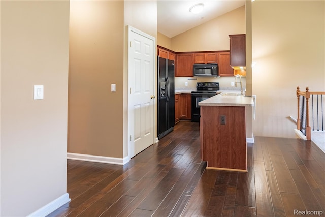 25556 Portico Ln, Novi, MI 48375 - kitchen featuring black appliances, a peninsula, dark wood-style flooring, brown cabinetry, and high vaulted ceiling
