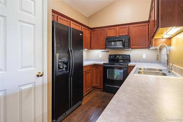 25556 Portico Ln, Novi, MI 48375 - kitchen with black appliances, vaulted ceiling, light countertops, dark wood-type flooring, and brown cabinets