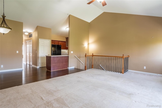 25556 Portico Ln, Novi, MI 48375 - unfurnished living room with dark carpet, a ceiling fan, high vaulted ceiling, and dark wood-style floors