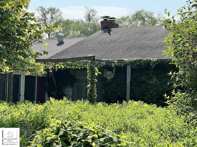 7379 N Irish Rd, Otisville, MI 48463 - view of home's exterior with roof with shingles and a chimney
