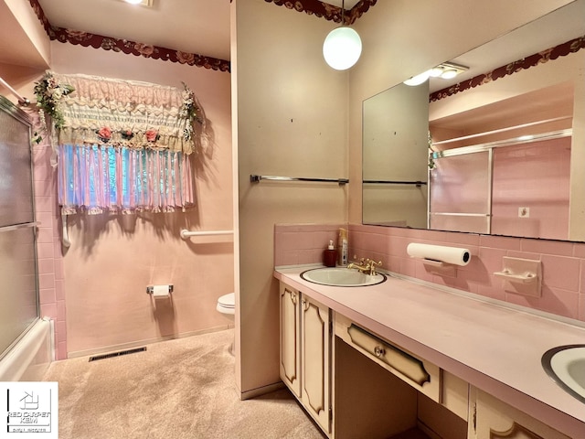 7379 N Irish Rd, Otisville, MI 48463 - full bathroom with double vanity, backsplash, and combined bath / shower with glass door