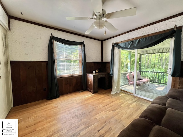 7379 N Irish Rd, Otisville, MI 48463 - living room with ornamental molding, light wood finished floors, wainscoting, a ceiling fan, and a textured wall