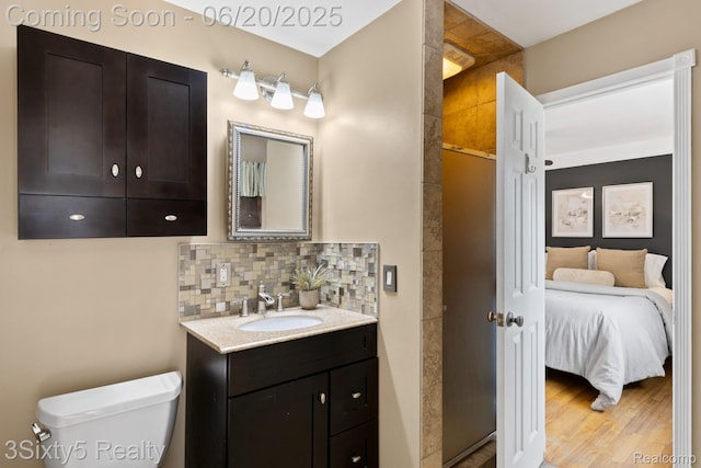 15615 S Midway Ave, Allen Park, MI 48101 - ensuite bathroom featuring vanity, tasteful backsplash, a shower with shower door, and wood finished floors