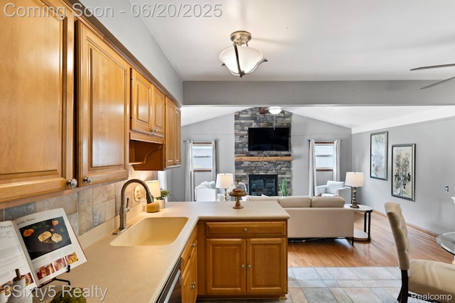15615 S Midway Ave, Allen Park, MI 48101 - kitchen with lofted ceiling, a peninsula, healthy amount of natural light, open floor plan, and a stone fireplace