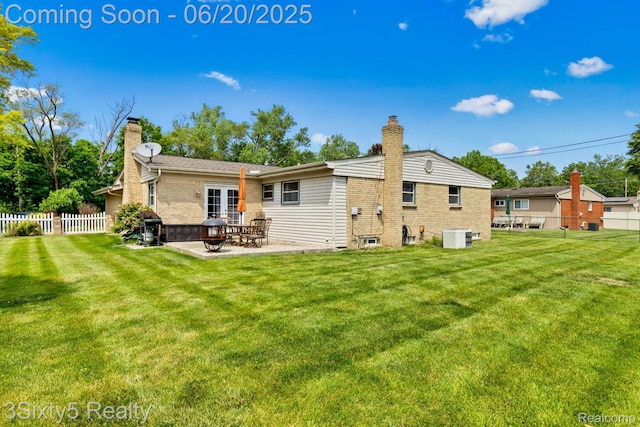 15615 S Midway Ave, Allen Park, MI 48101 - back of house with a chimney, brick siding, and a patio