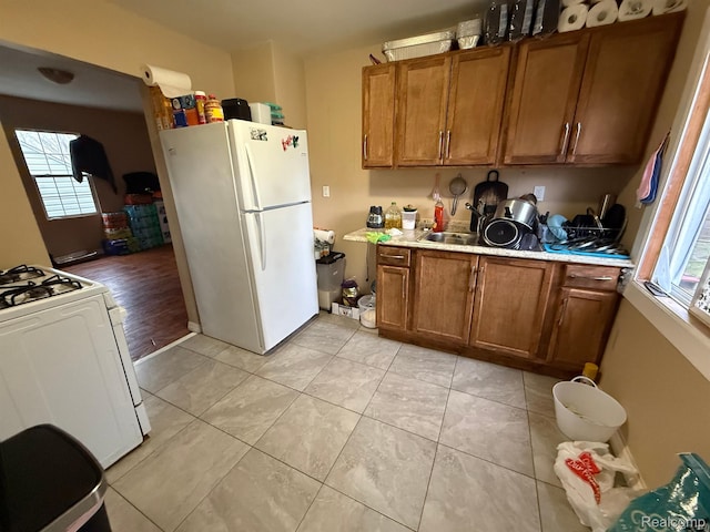 9208 Ward St, Detroit, MI 48228 - kitchen featuring white appliances, brown cabinetry, light countertops, and light tile patterned flooring