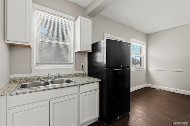 4334 Pacific St, Detroit, MI 48204 - kitchen with freestanding refrigerator, dark wood-type flooring, white cabinets, and light countertops