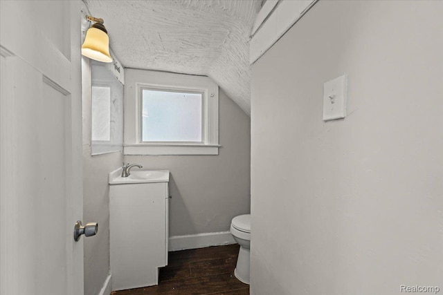 4334 Pacific St, Detroit, MI 48204 - half bath with vanity, vaulted ceiling, and wood finished floors