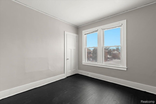 4334 Pacific St, Detroit, MI 48204 - empty room featuring dark wood-style flooring and crown molding