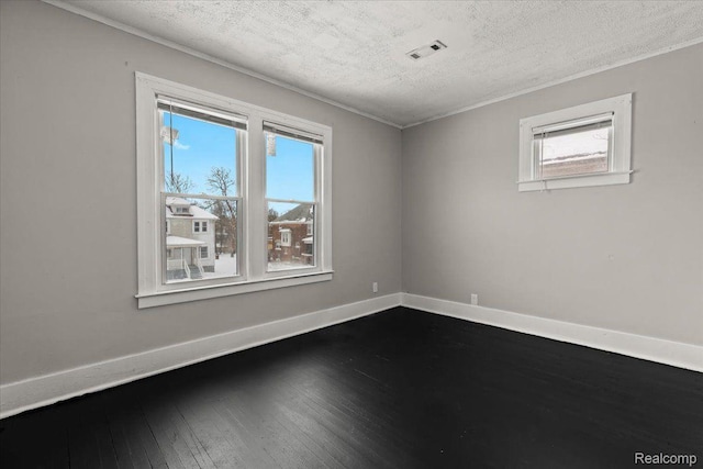 4334 Pacific St, Detroit, MI 48204 - spare room featuring healthy amount of natural light, a textured ceiling, and dark wood-type flooring