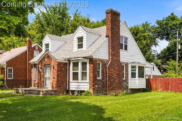 11108 Craft St, Detroit, MI 48224 - view of front of house featuring brick siding, a chimney, and a shingled roof