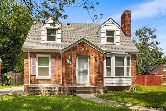 11108 Craft St, Detroit, MI 48224 - cape cod-style house featuring a chimney, roof with shingles, and brick siding