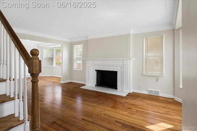 11108 Craft St, Detroit, MI 48224 - unfurnished living room with ornamental molding, stairway, wood finished floors, and a fireplace