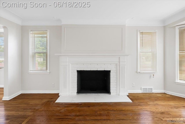 11108 Craft St, Detroit, MI 48224 - detailed view of a brick fireplace, wood finished floors, arched walkways, and crown molding