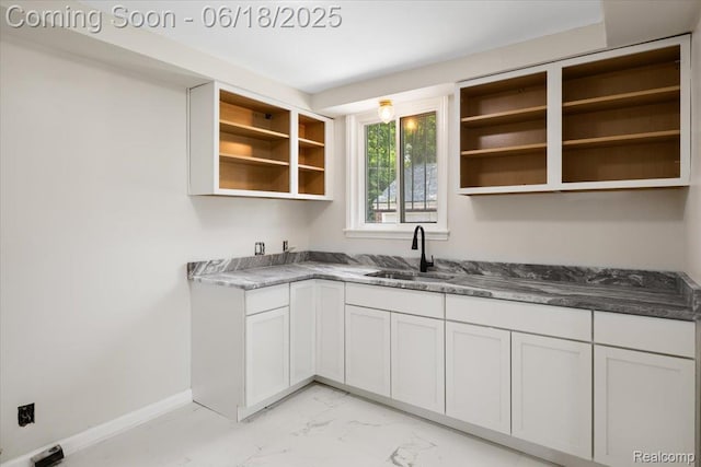11108 Craft St, Detroit, MI 48224 - kitchen with open shelves, light marble finish floors, and white cabinetry