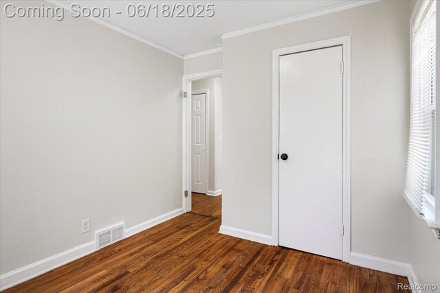 11108 Craft St, Detroit, MI 48224 - unfurnished bedroom with wood finished floors, crown molding, and multiple windows