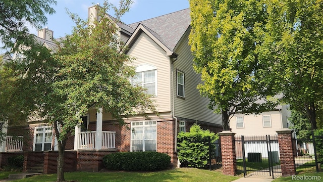 870 Lothrop Rd Unit 6/1, Detroit, MI 48202 - view of front of home featuring brick siding, a gate, and a porch