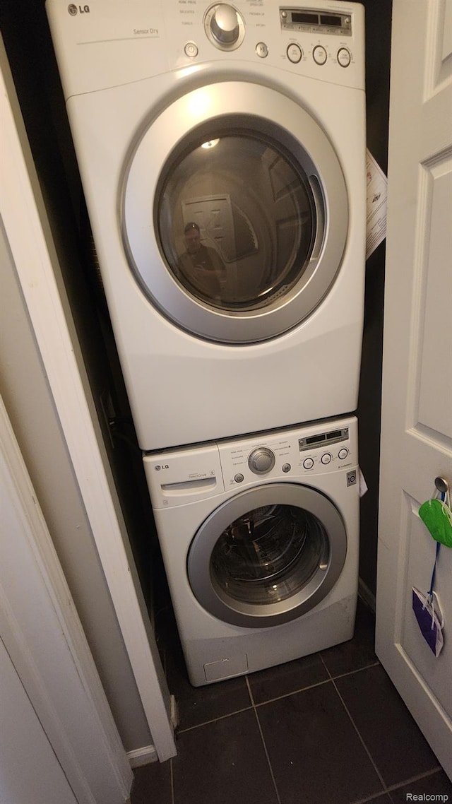 870 Lothrop Rd Unit 6/1, Detroit, MI 48202 - laundry room featuring stacked washer / drying machine and dark tile patterned floors