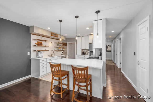 431 Homecrest Ave, Kalamazoo, MI 49001 - kitchen featuring dark wood-style floors, white cabinetry, light countertops, a peninsula, and recessed lighting