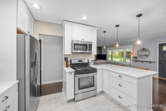 431 Homecrest Ave, Kalamazoo, MI 49001 - kitchen with appliances with stainless steel finishes, a peninsula, light countertops, and recessed lighting