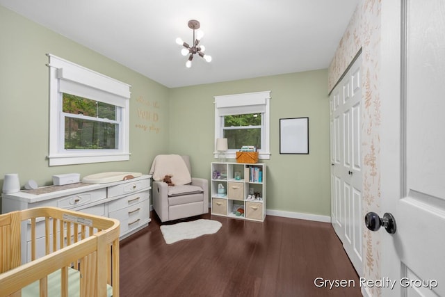 431 Homecrest Ave, Kalamazoo, MI 49001 - bedroom featuring multiple windows, wood finished floors, a chandelier, and a nursery area