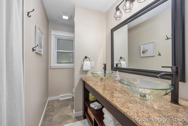 431 Homecrest Ave, Kalamazoo, MI 49001 - full bath with double vanity and baseboards